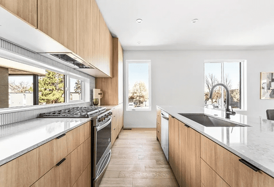 Bright modern kitchen with wood cabinets and island