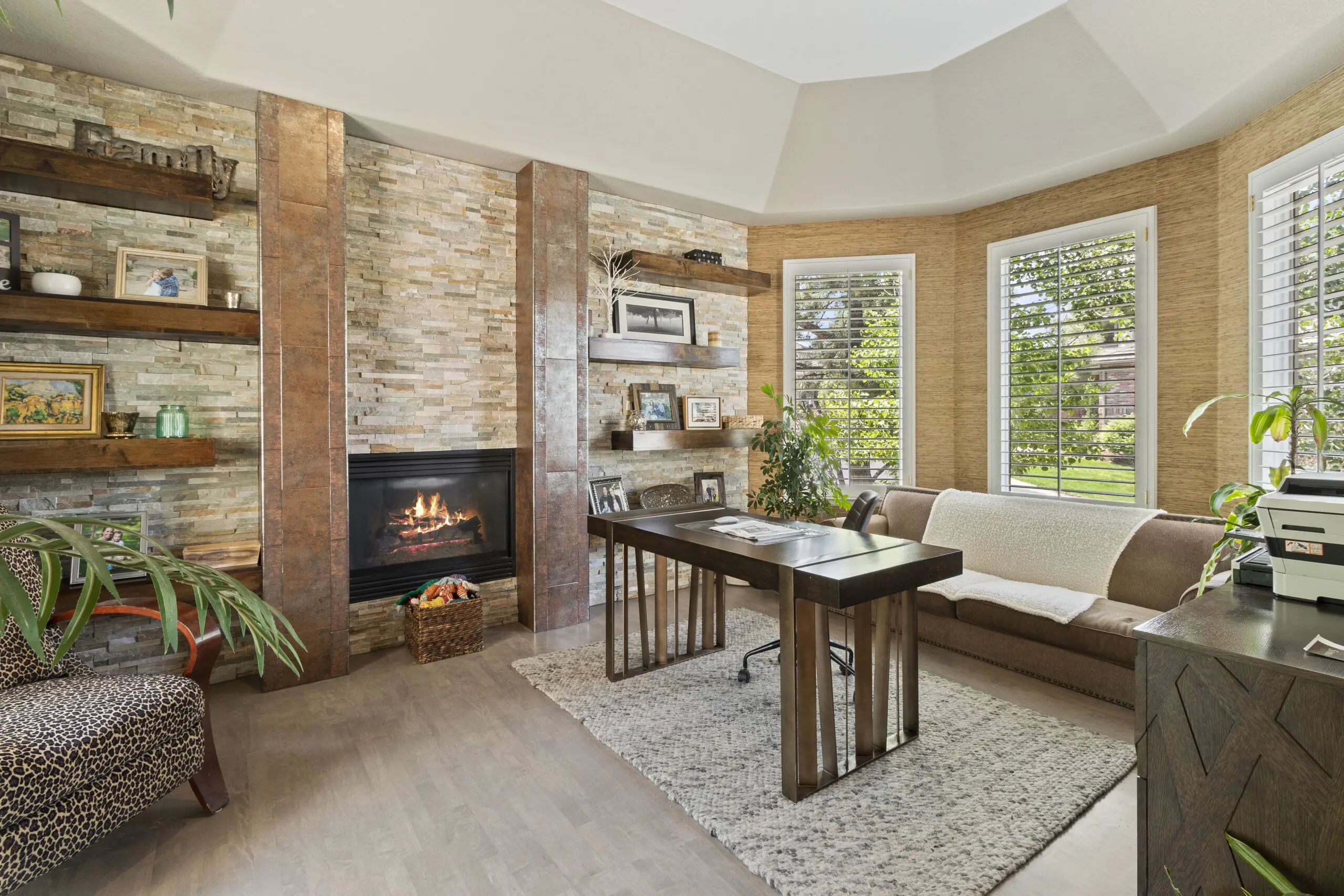 Cozy home office with fireplace and bay windows