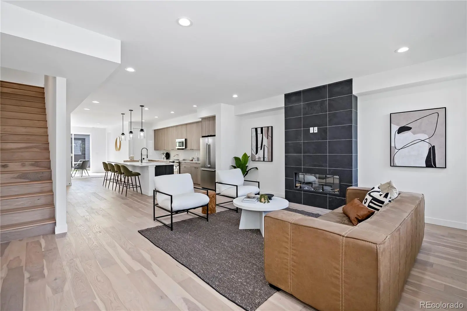 Modern open-concept living room with black fireplace