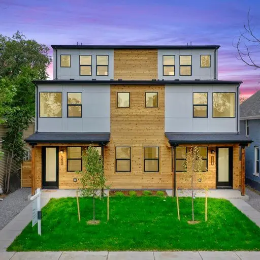Modern duplex with wood siding and lawn